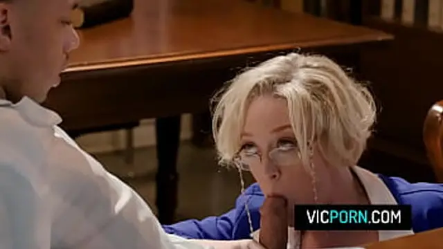 Busty mature Dee Williams getting double penetrated by two horny students in the library