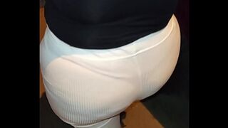 Curvaceous lady adorned with red thread —  sizzling under see-through pants on the sidewalk
